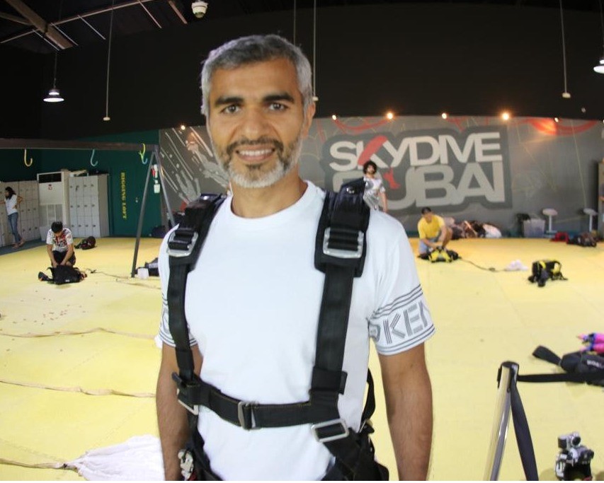 Umar Farooq Zahoor smiling inside the Skydive Dubai facility, wearing a harness and preparing for an adventure.